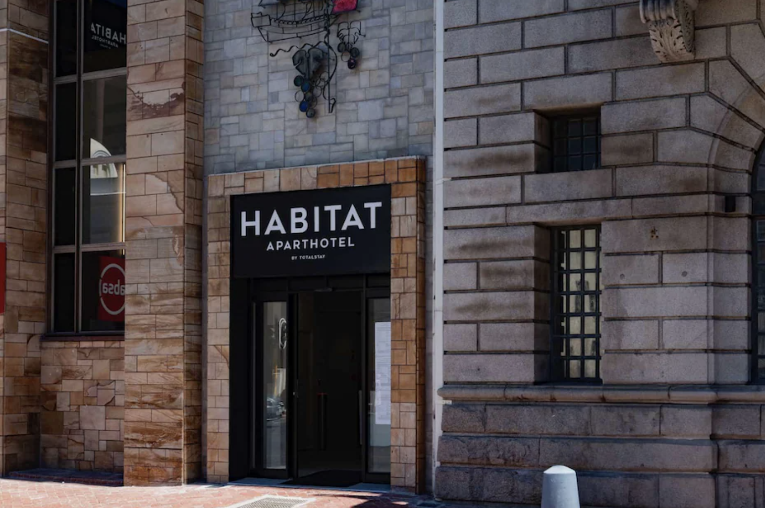 Habitat Aparthotel exterior signage
